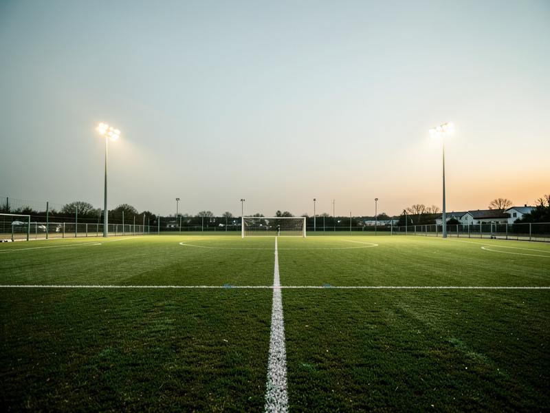 Floodlit soccer pitch at dusk